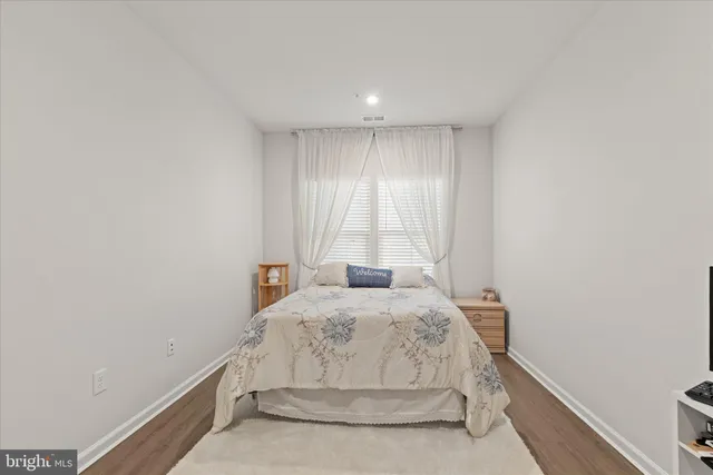 a bedroom with a bed and flat screen tv