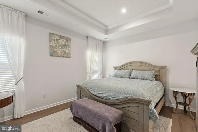 a bedroom with a bad and dresser