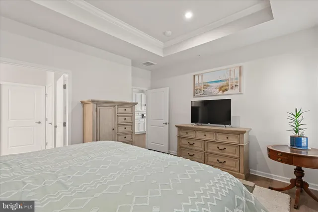 a bedroom with a bed and a television