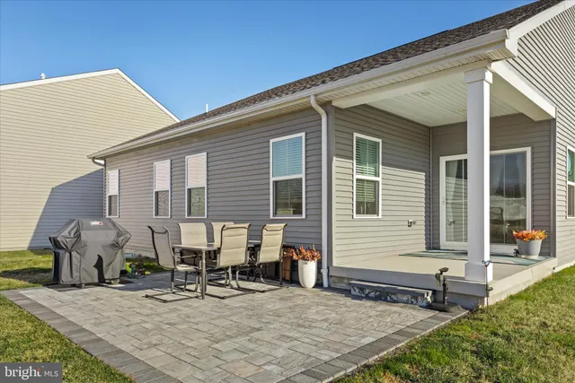 a view of a two chair and a potted plant in back of the house