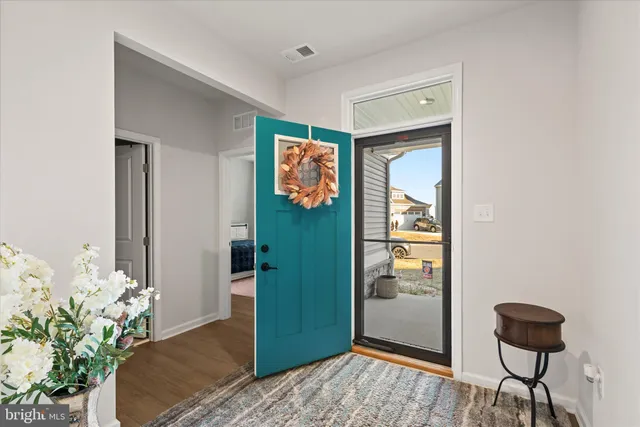 a bedroom with a bed and a potted plant