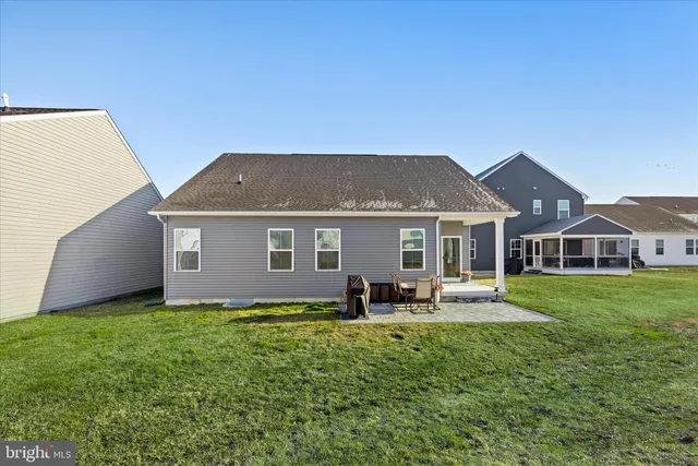 a view of a house with a yard and sitting area