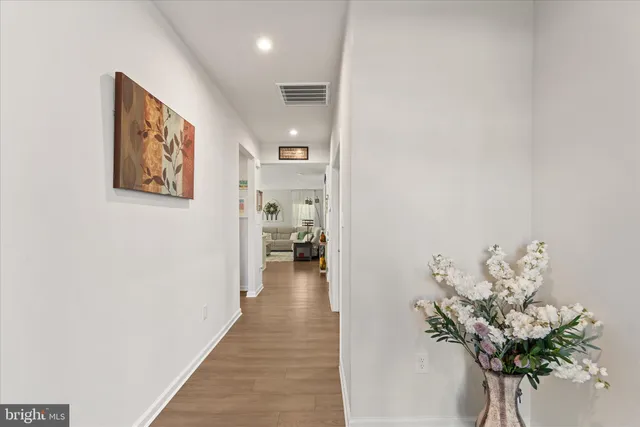 a hallway with painting on the wall