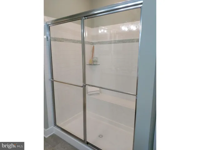 a bathroom with a glass shower door