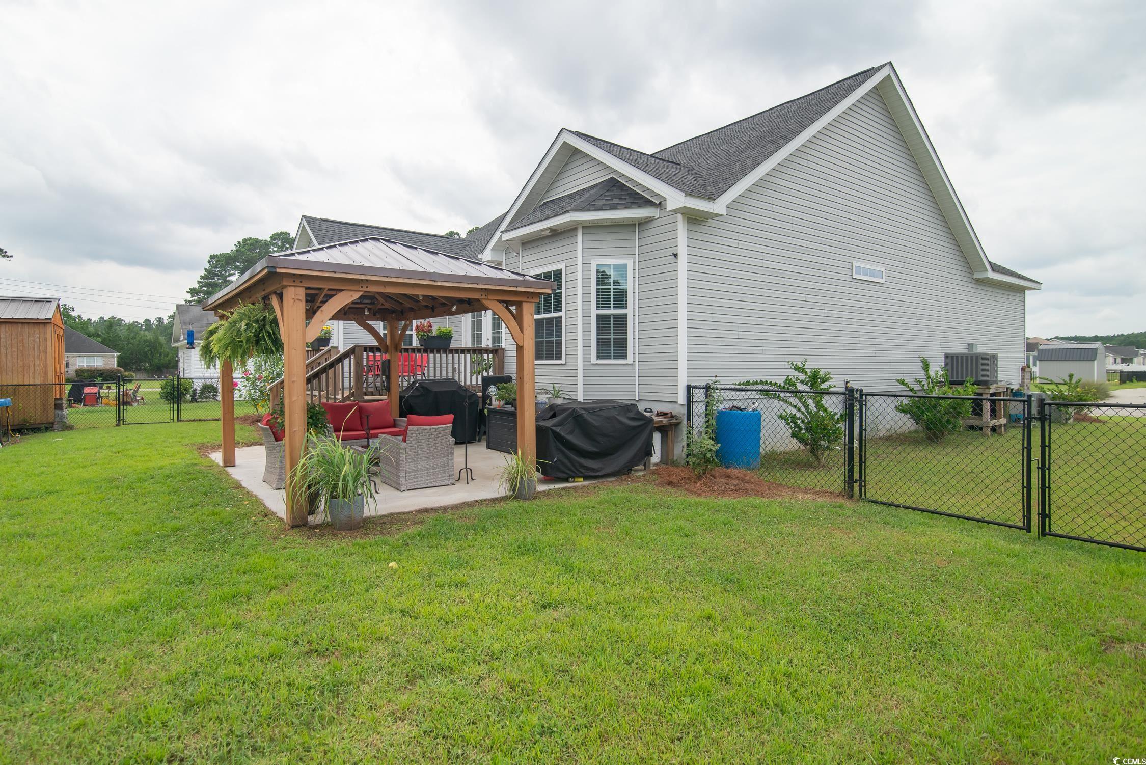 2242 Brier Street Georgetown, SC 29440 - Photo 20 of 29 Rear view of property with a patio, a yard, a gaze