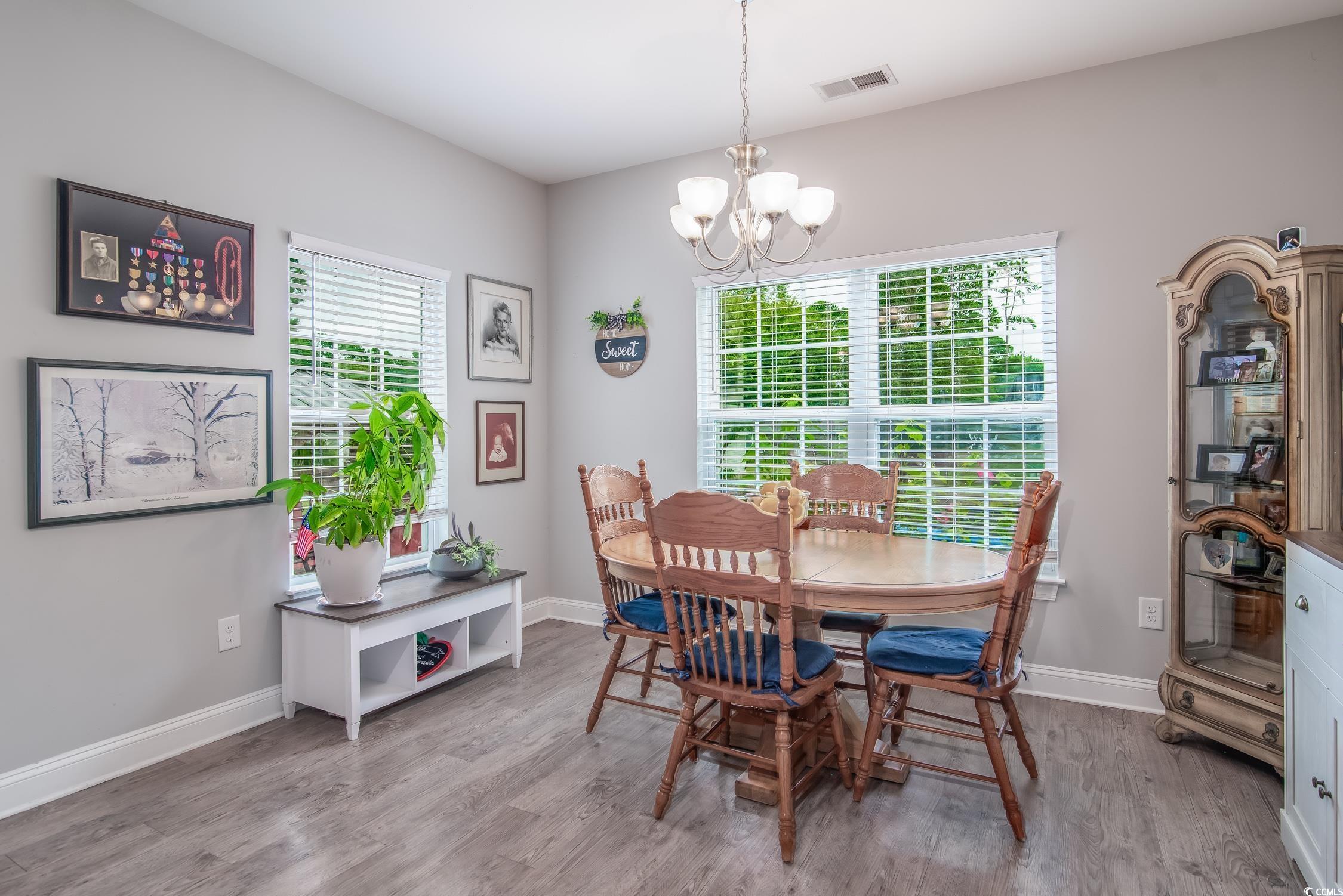 2242 Brier Street Georgetown, SC 29440 - Photo 10 of 29 Dining space with an inviting chandelier and hardw