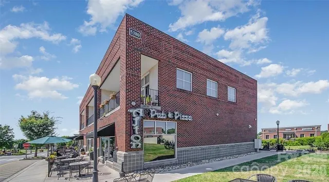 a street sign on a sidewalk next to a road
