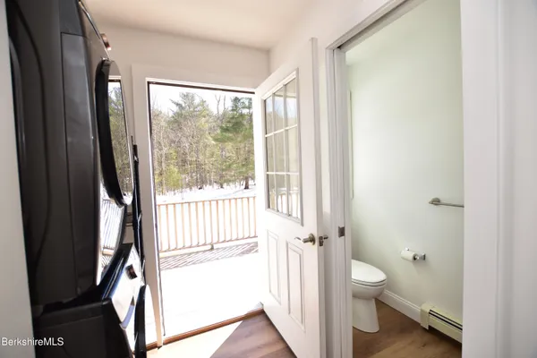 a bathroom with a toilet a sink and a large window