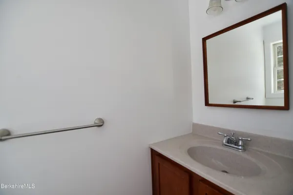a bathroom with a sink vanity and mirror