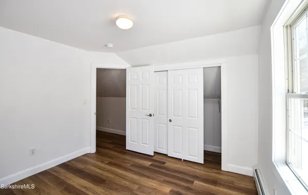 a view of a livingroom with wooden floor and window