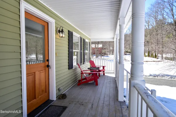 a balcony with furniture and wooden floor