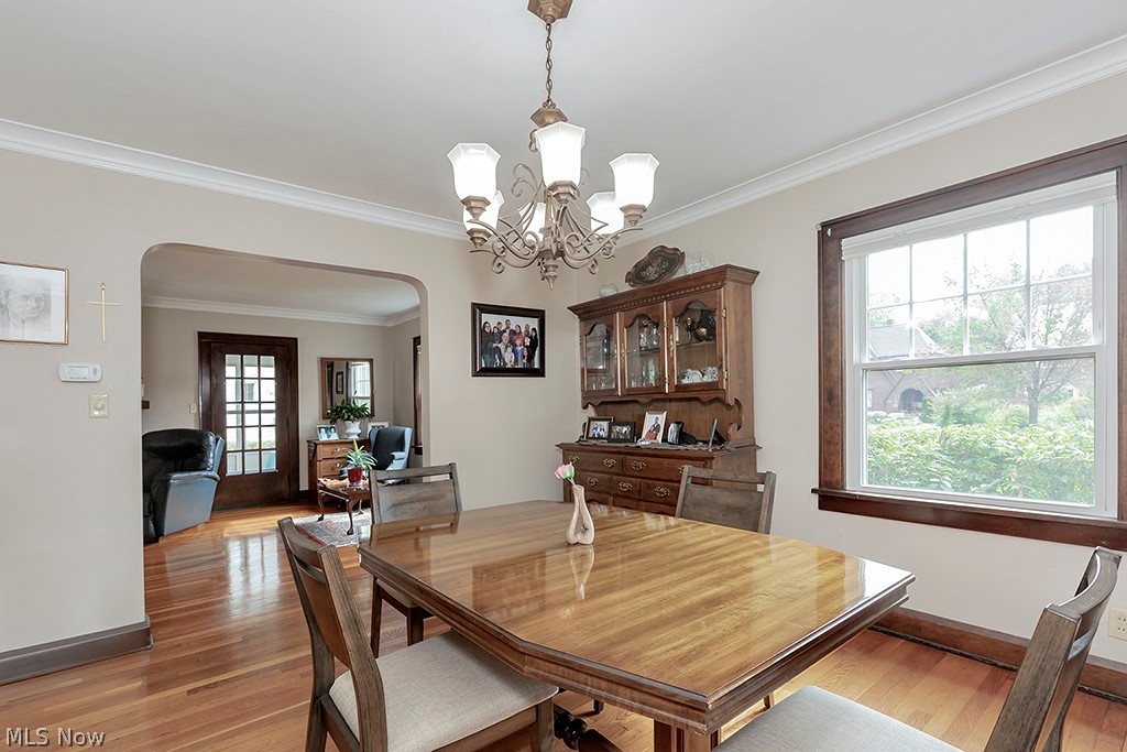 2480 Eaton Road Cleveland, OH 44118 - Photo 8 of 41 Dining room featuring an inviting chandelier, crown molding, and hardwood / wood-style flooring