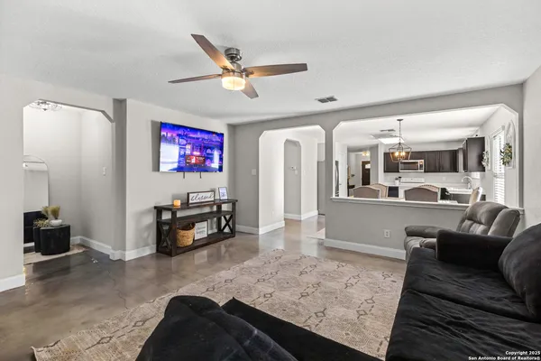 a living room with furniture and a wooden floor