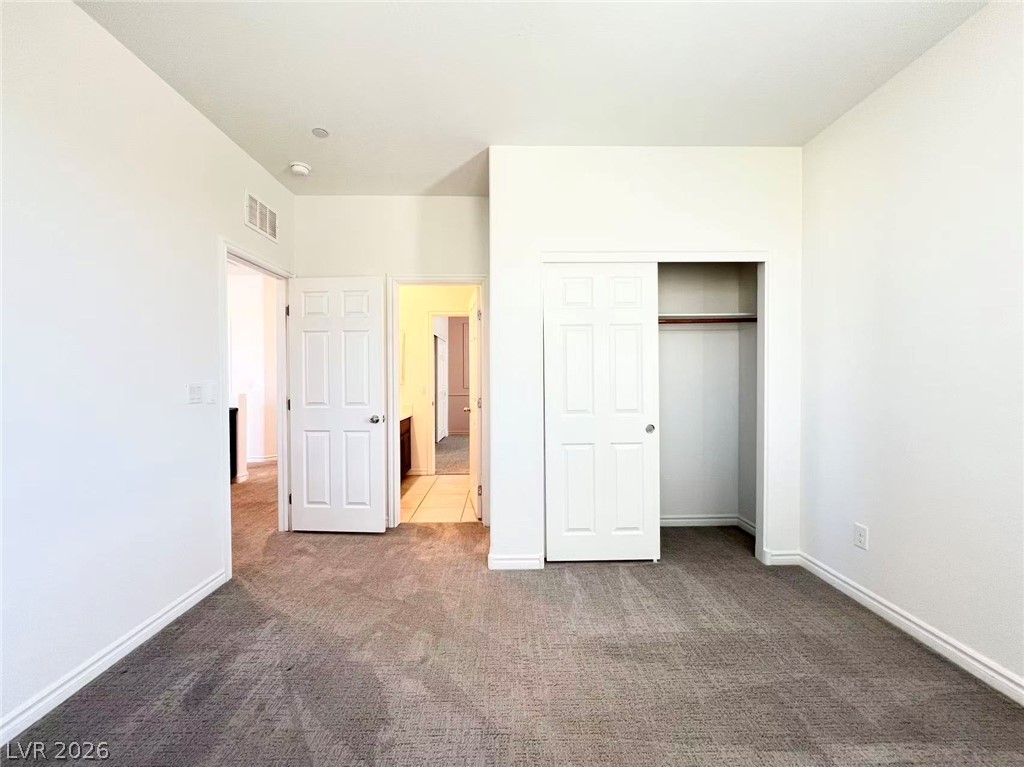 925 Bayberry Ridge Street Henderson, NV 89052 - Photo 18 of 27 A well-maintained interior offers comfortable living with neutral tones and soft carpeting.