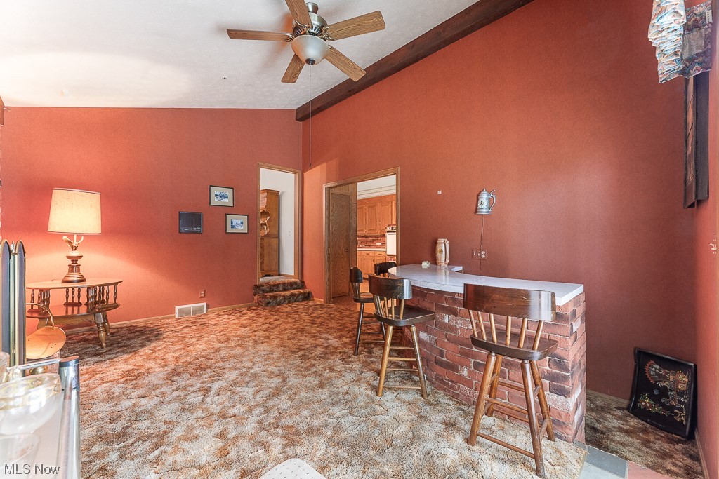 19235 West Middletown Road Beloit, OH 44609 - Photo 15 of 35 Carpeted dining space featuring vaulted ceiling and ceiling fan