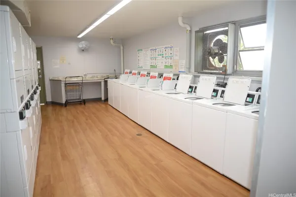 a kitchen with a sink cabinets and wooden floor