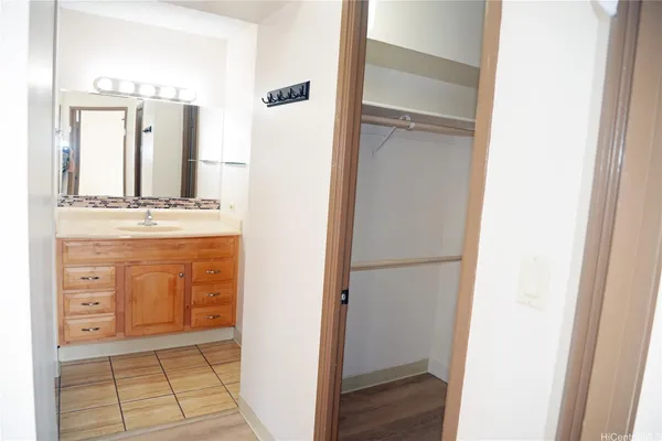 a view of a kitchen from the hallway with closet
