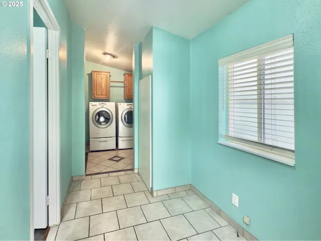a view of a hallway with a washer and dryer