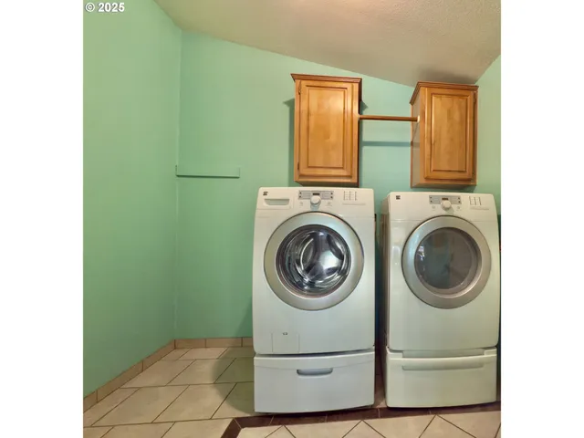 a view of storage and utility room with washer and dryer