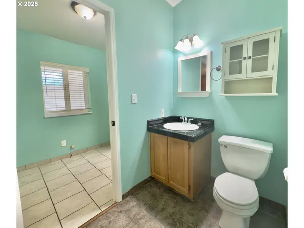 a bathroom with a toilet sink and mirror