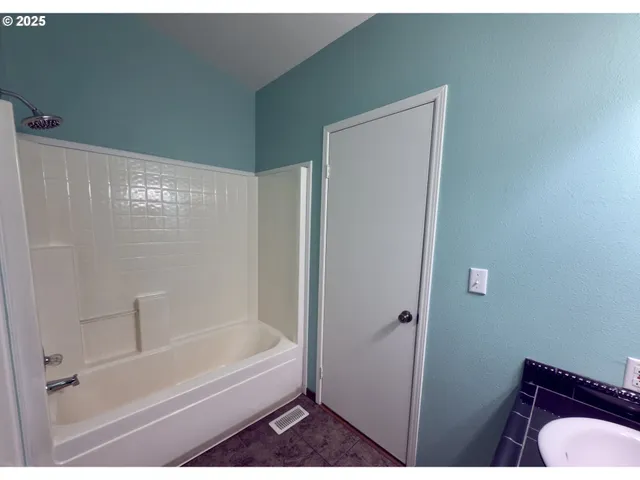 a bathroom with a bathtub and shower