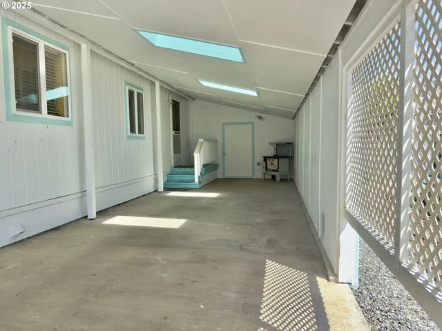a view of a hallway with wooden floor and a dining room