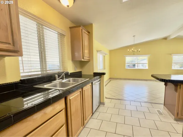 a kitchen with a sink and a stove top oven
