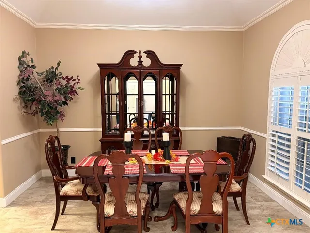 a bed sitting in a spacious bedroom next to a window