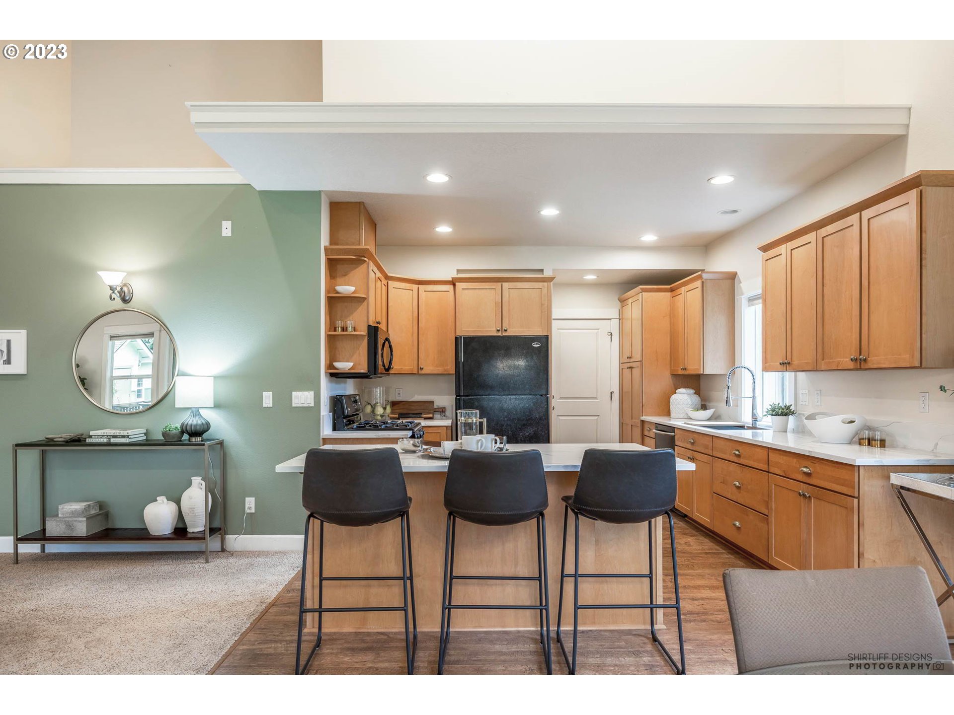 84 Federal Lane Eugene, OR 97404 - Photo 12 of 32 a kitchen with stainless steel appliances kitchen island granite countertop a dining table chairs and a refrigerator