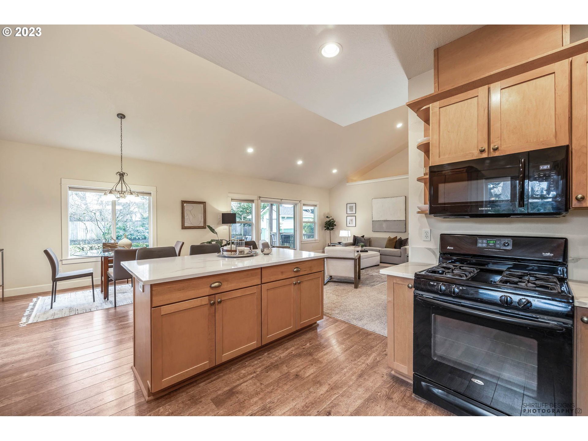 84 Federal Lane Eugene, OR 97404 - Photo 14 of 32 a kitchen with stainless steel appliances kitchen island granite countertop a stove top oven a sink a dining table and chairs