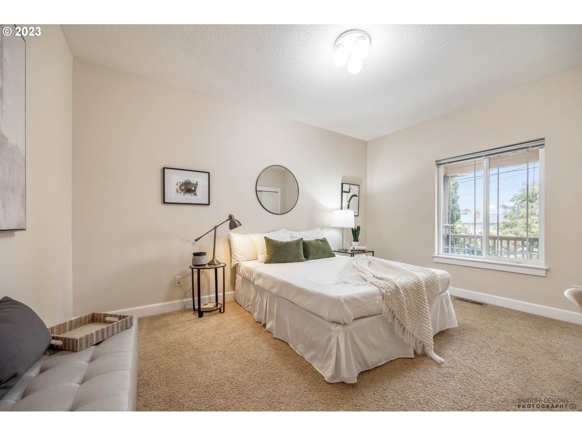 84 Federal Lane Eugene, OR 97404 - Photo 23 of 32 a bedroom with a bed lamp and a large window