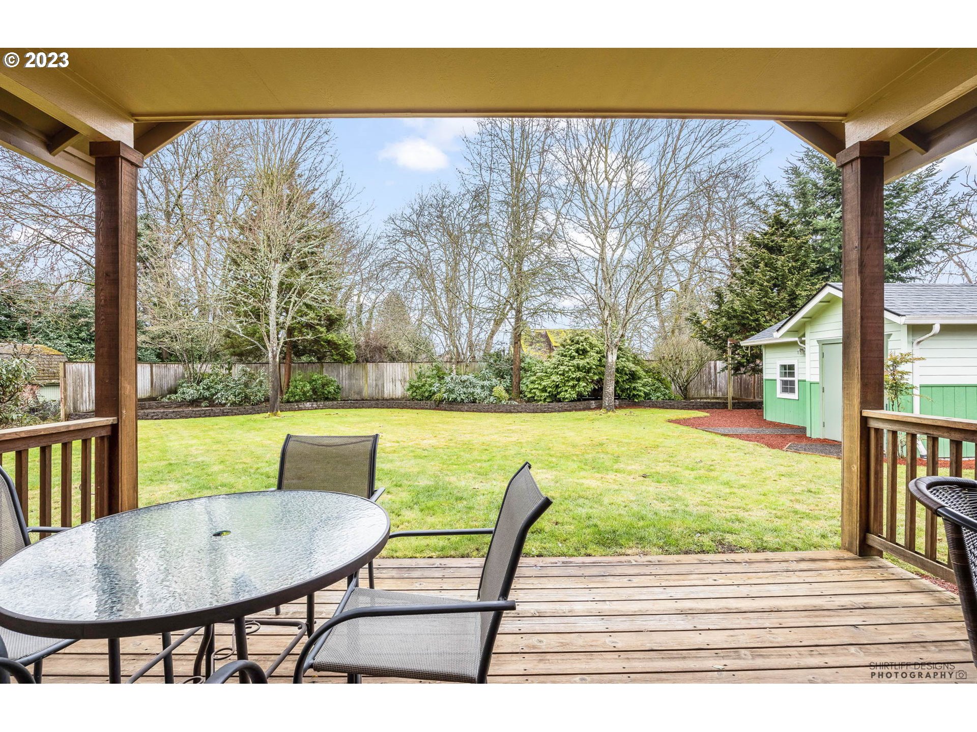 84 Federal Lane Eugene, OR 97404 - Photo 27 of 32 a view of a patio with table and chairs potted plants with wooden floor and fence