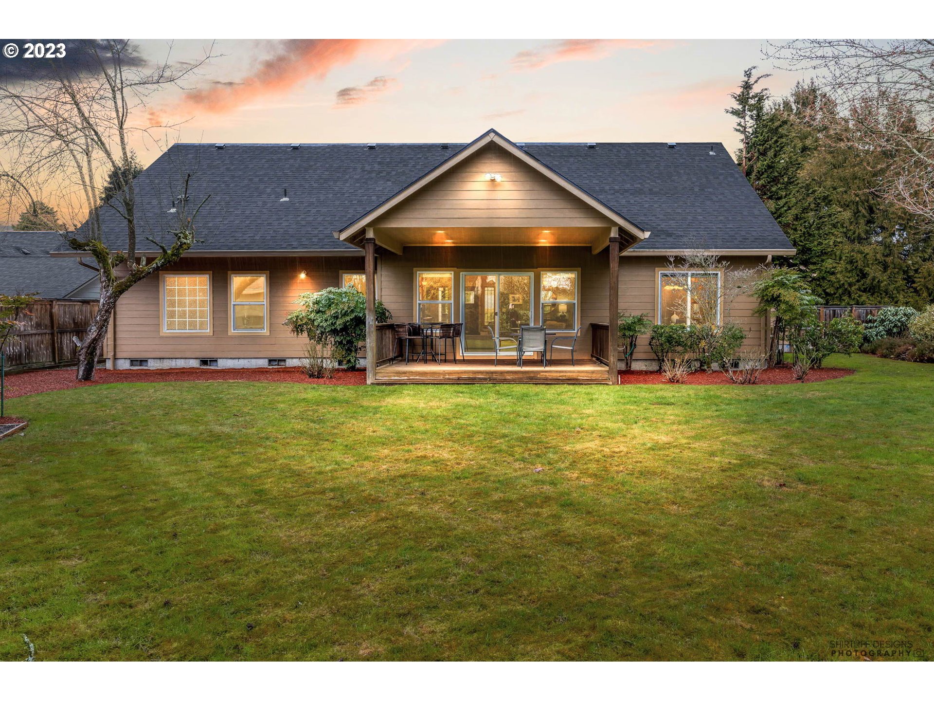 84 Federal Lane Eugene, OR 97404 - Photo 31 of 32 a view of a big house with table and chairs under an umbrella