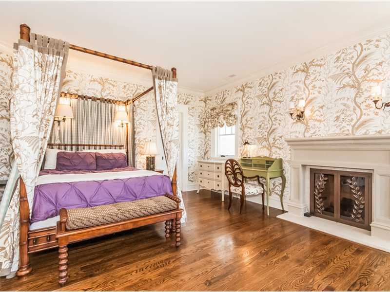 38 Hunting Ridge Lane Wilton, CT 06897 - Photo 22 of 25 a spacious bedroom with a bed and a fireplace