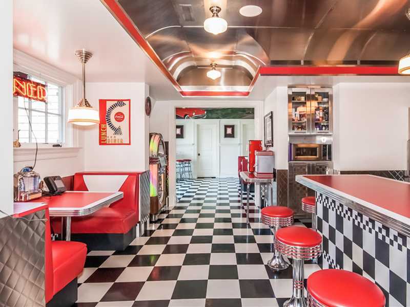 38 Hunting Ridge Lane Wilton, CT 06897 - Photo 24 of 25 a living room with a black white checkered floor with couches and a dining table with chairs
