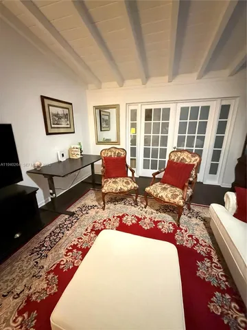 a living room with furniture fireplace and wooden floor