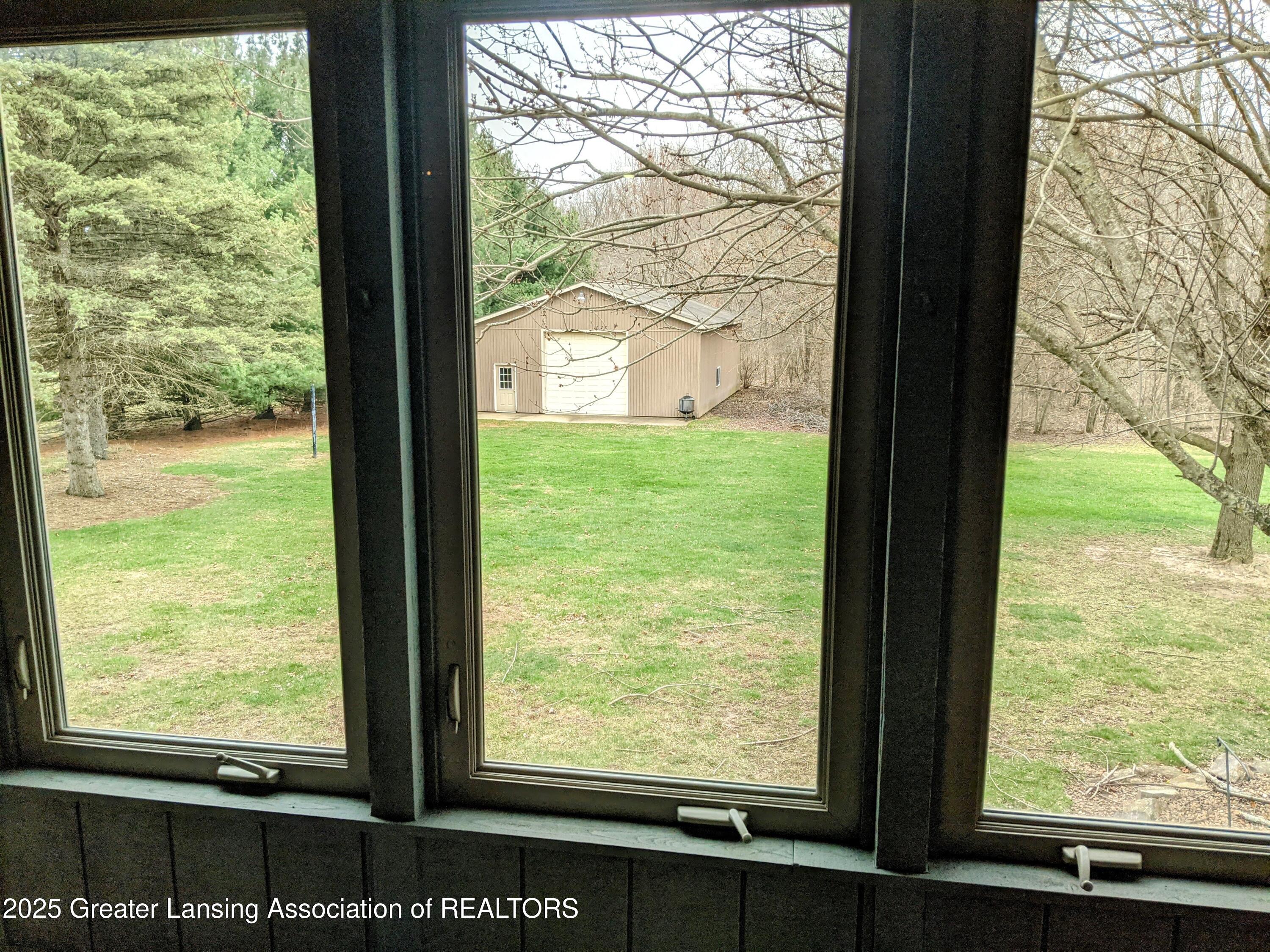 2600 East Round Lake Road Dewitt, MI 48820 - Photo 20 of 37 View From Sunroom to Back Yard