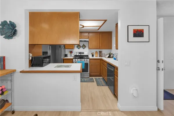 a kitchen with stainless steel appliances granite countertop a sink a stove and a refrigerator