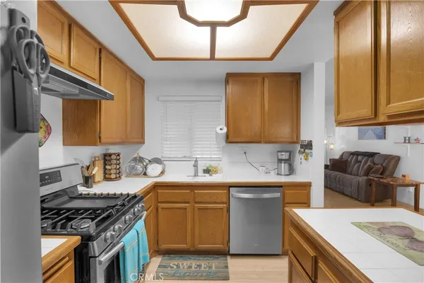 a kitchen with a sink appliances and cabinets
