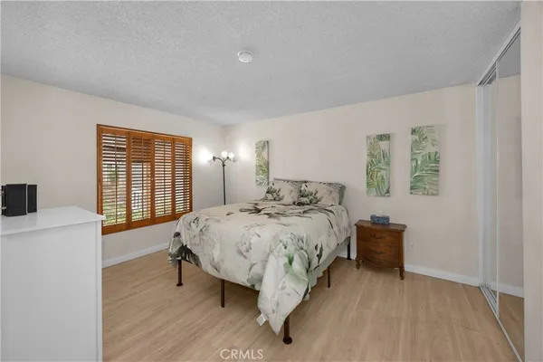 a bed sitting in a bedroom next to a window