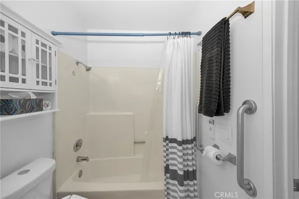 a bathroom with a shower curtain and a shower curtain