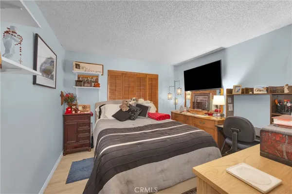 a bedroom with bed and a flat screen tv