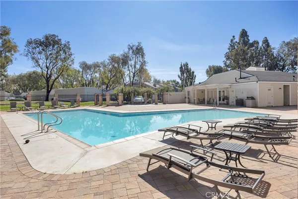 a view of a swimming pool with lounge chairs