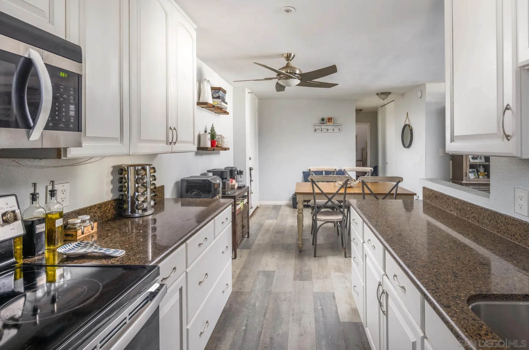6333 La Jolla Boulevard, Unit 170 La Jolla, CA 92037 - Photo 2 of 18 a kitchen with stainless steel appliances granite countertop a sink stove and cabinets