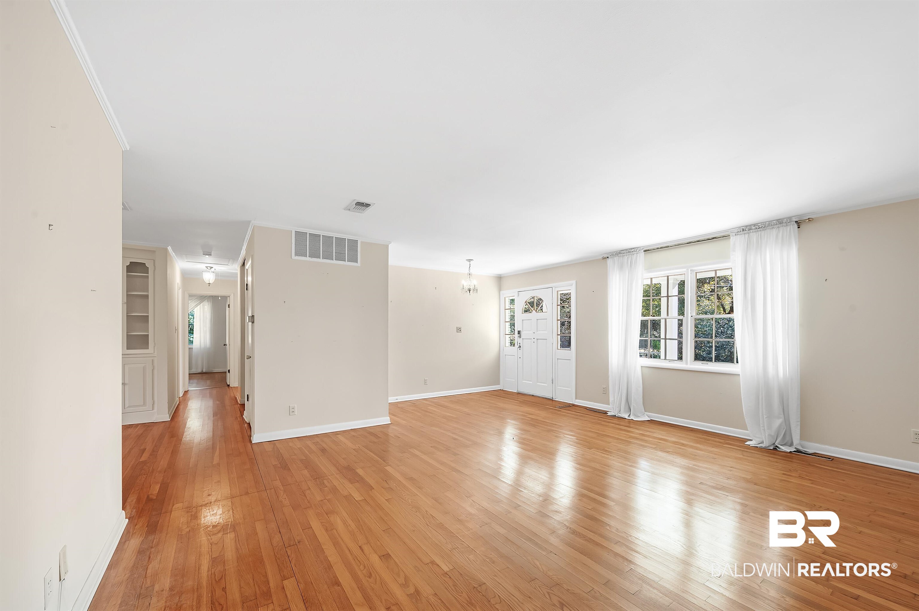 14375 Oak Street Magnolia Springs, AL 36555 - Photo 7 of 20 Unfurnished living room with hardwood flooring and a chandelier