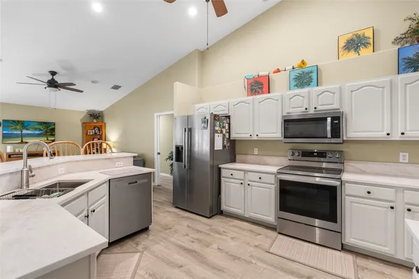 a kitchen with stainless steel appliances granite countertop a sink and a stove