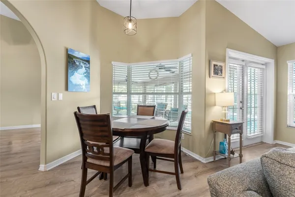a view of a dining room with furniture and a window