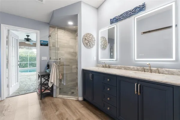 a bathroom with a granite countertop sink and a mirror