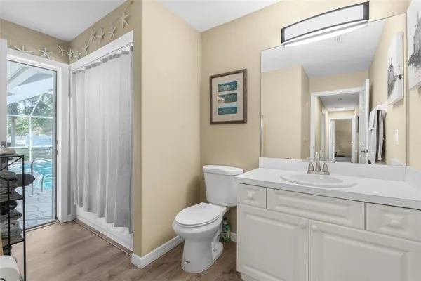 a bathroom with a toilet a sink and a mirror