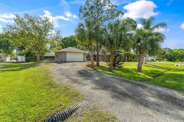 a house with green field in front of it